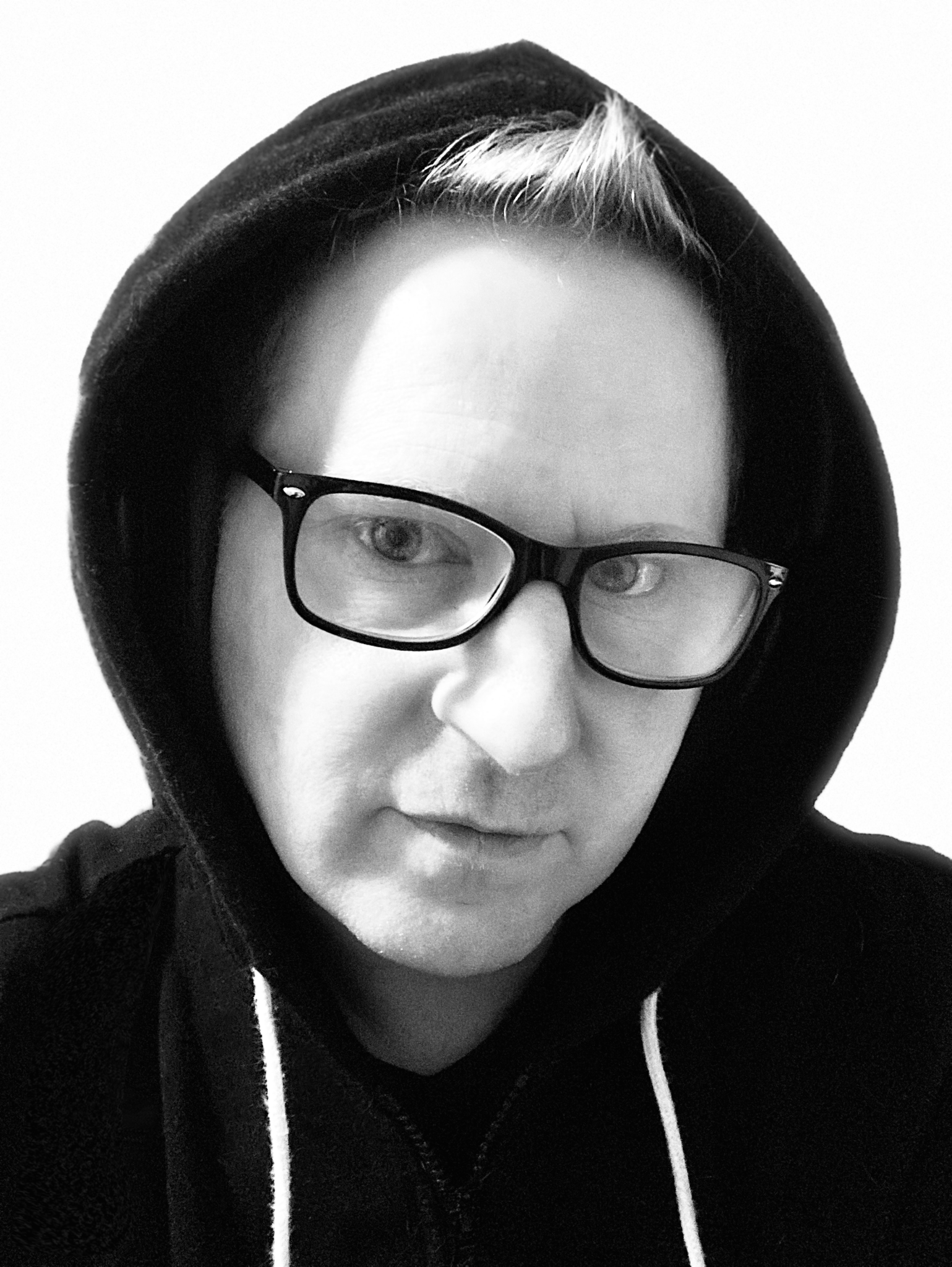 Headshot of Isaac Toast in a hoodie wearing eyeglasses.